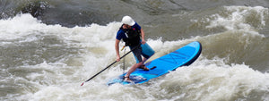 Whitewater SUP Paddler on River Rapids