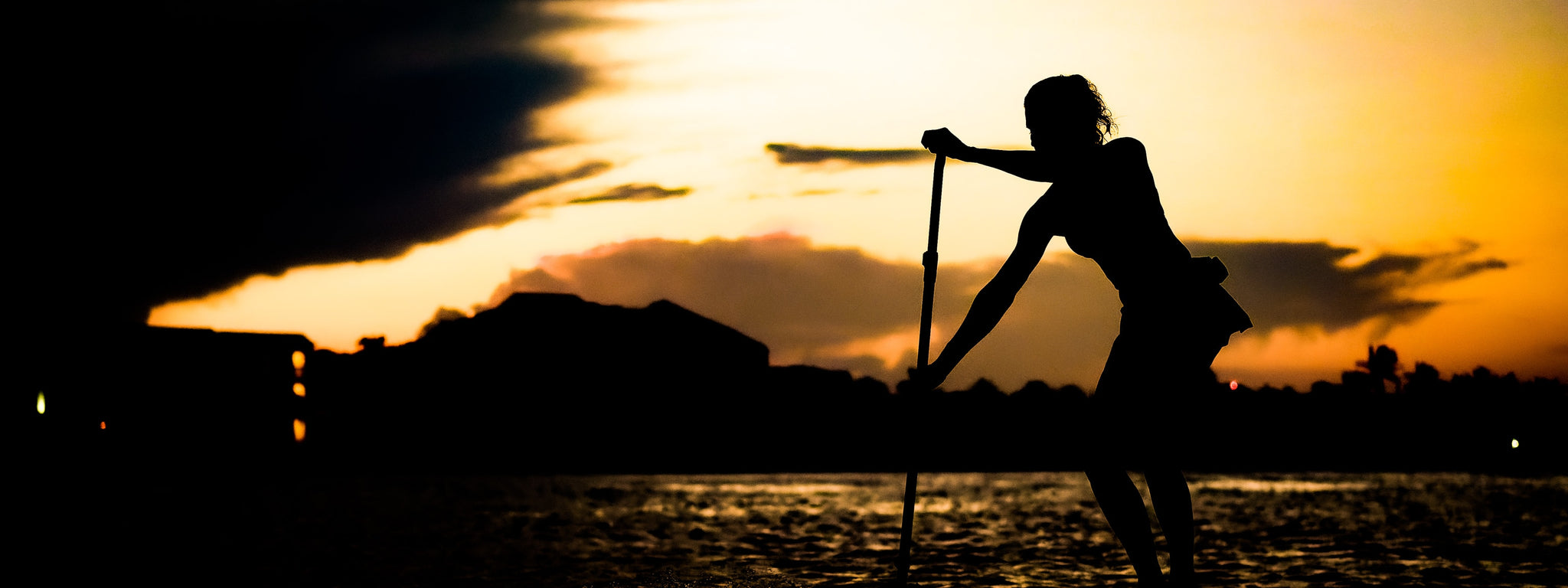 Earth River SUP paddling on rough water at sunset